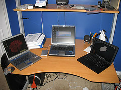 Three laptops on a computer table