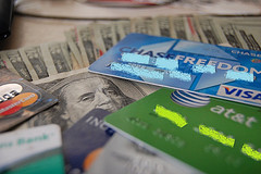 Several credit cards and dollar bills