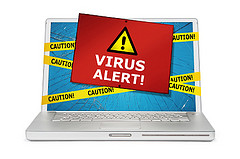 Virus alert note over an open laptop